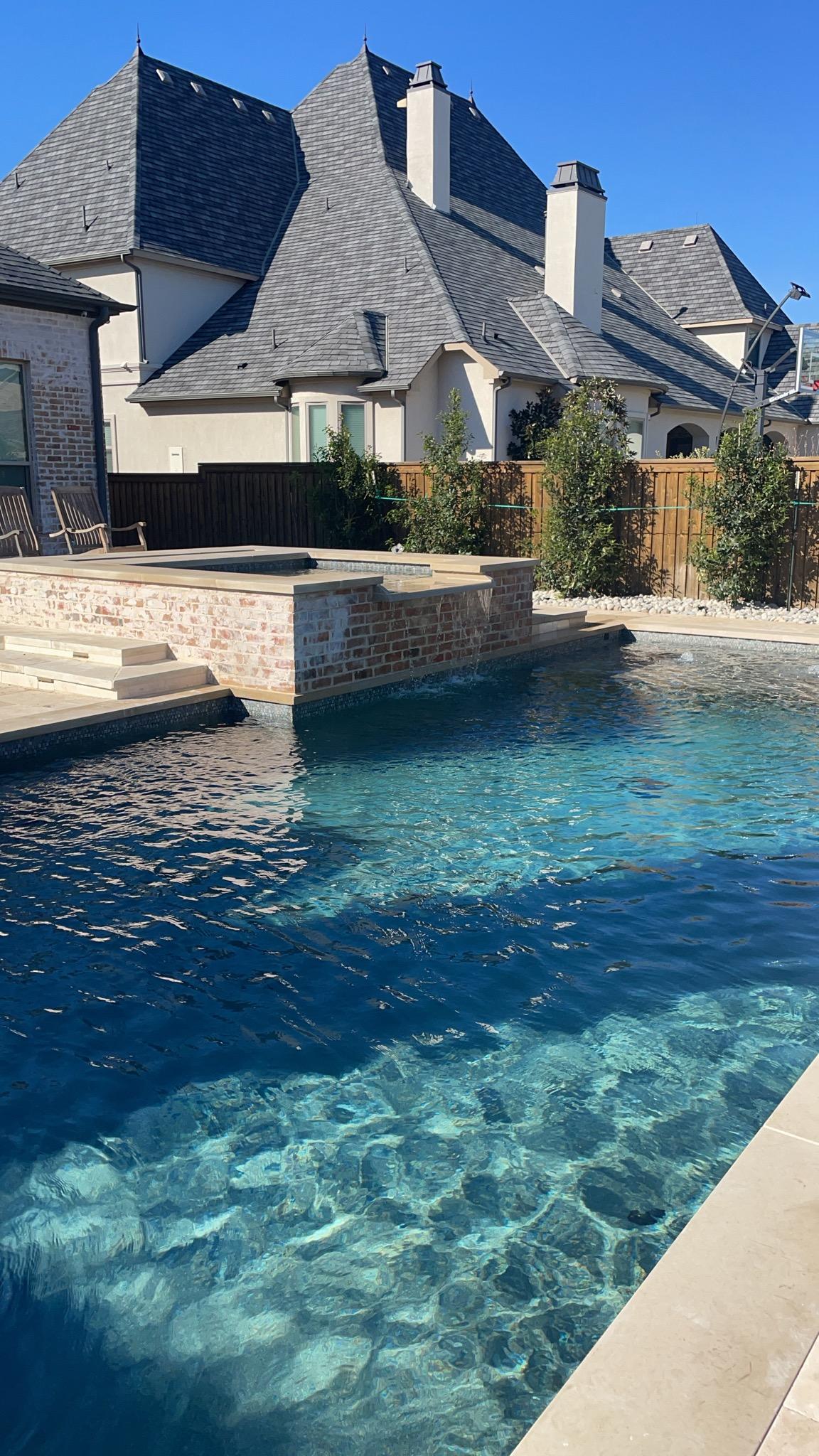 Backyard pool with clear blue water after pool service